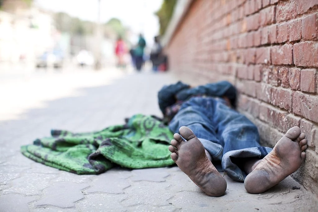 Beggar Sleeping On The Street